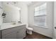 Modern bathroom with gray vanity and large mirror at 3075 Westpoint Cir, Snellville, GA 30078