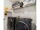 Bright laundry room with Samsung washer and dryer and shelving for storage at 3075 Westpoint Cir, Snellville, GA 30078