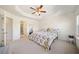 Main bedroom with a floral comforter, ceiling fan, and ensuite bathroom at 3075 Westpoint Cir, Snellville, GA 30078