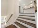 Modern staircase with dark wood treads and white risers leading to the upper level at 3075 Westpoint Cir, Snellville, GA 30078