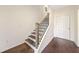 Modern staircase with dark wood treads and black metal balusters at 3075 Westpoint Cir, Snellville, GA 30078