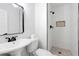 Modern bathroom with white subway tiles, walk-in shower, and pedestal sink at 6231 Creekford Dr, Lithonia, GA 30058