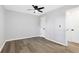 Bedroom with hardwood floors, ceiling fan and access to hallway at 6231 Creekford Dr, Lithonia, GA 30058