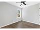 Bright bedroom featuring wood-look floors and ceiling fan at 6231 Creekford Dr, Lithonia, GA 30058