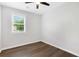 Well-lit bedroom with wood-look floors and window with blinds at 6231 Creekford Dr, Lithonia, GA 30058