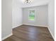 Simple bedroom with wood-look floors and a window with blinds at 6231 Creekford Dr, Lithonia, GA 30058