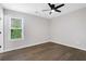 Well-lit bedroom with ceiling fan and hardwood floors at 6231 Creekford Dr, Lithonia, GA 30058
