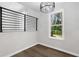 Dining room with wood-look floors, modern chandelier, and view to backyard at 6231 Creekford Dr, Lithonia, GA 30058