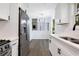 Open concept kitchen with stainless steel appliances and a breakfast bar at 6231 Creekford Dr, Lithonia, GA 30058