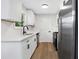 Renovated kitchen boasts stainless steel appliances and white cabinetry at 6231 Creekford Dr, Lithonia, GA 30058