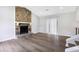 Open living room with stone fireplace and sliding glass doors at 6231 Creekford Dr, Lithonia, GA 30058