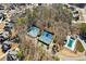 Aerial view of the neighborhood amenities including tennis courts and a swimming pool at 1449 Brentford Cv, Snellville, GA 30078