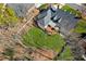 Aerial view of the backyard with a firepit and mature trees at 1449 Brentford Cv, Snellville, GA 30078