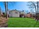 A large backyard with a well-maintained lawn featuring a spacious deck, steps, and privacy fence at 1449 Brentford Cv, Snellville, GA 30078