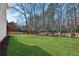 Spacious, green backyard featuring a fire pit and a deck with stairs leading down to the grassy lawn at 1449 Brentford Cv, Snellville, GA 30078