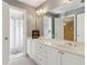 Bathroom featuring double sinks, vanity, mirror and open doorway to shower and toilet at 1449 Brentford Cv, Snellville, GA 30078