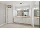 Bathroom featuring double sinks, vanity, mirror, and crown molding at 1449 Brentford Cv, Snellville, GA 30078