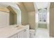 Bathroom featuring a sink, toilet, shower, and window providing natural light at 1449 Brentford Cv, Snellville, GA 30078