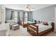 Bright bedroom with two twin beds, ceiling fan and adjacent sitting area at 1449 Brentford Cv, Snellville, GA 30078