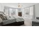 Bedroom with an exterior door featuring natural light, neutral walls and carpet, and a ceiling fan at 1449 Brentford Cv, Snellville, GA 30078