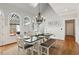 Sun-filled dining area featuring an elegant chandelier, a large table, and outdoor views at 1449 Brentford Cv, Snellville, GA 30078