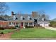 Charming home featuring a welcoming front porch, manicured lawn, and attached two-car garage at 1449 Brentford Cv, Snellville, GA 30078