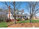 Beautiful exterior view of a home featuring a welcoming front porch, manicured lawn, and attached two-car garage at 1449 Brentford Cv, Snellville, GA 30078