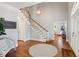 Spacious foyer with hardwood floors, staircase, and elegant lighting fixture, creating a grand entry at 1449 Brentford Cv, Snellville, GA 30078