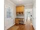 Hallway featuring a built-in desk, storage cabinets, and hardwood floors at 1449 Brentford Cv, Snellville, GA 30078