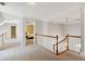 Upstairs hallway with decorative railing and chandelier at 1449 Brentford Cv, Snellville, GA 30078