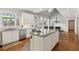 Sun-filled kitchen features a skylight, granite counters, and a large island with cooktop at 1449 Brentford Cv, Snellville, GA 30078