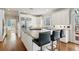 Bright kitchen features a granite island, stainless steel appliances, and sleek white cabinetry at 1449 Brentford Cv, Snellville, GA 30078