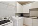 Laundry room featuring white appliances, cabinetry, sink, and countertops at 1449 Brentford Cv, Snellville, GA 30078