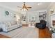 Inviting living room featuring hardwood floors, built-in bookshelves, and a comfortable seating area at 1449 Brentford Cv, Snellville, GA 30078