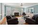 Elegant living room with fireplace, hardwood floors, and a comfortable seating arrangement at 1449 Brentford Cv, Snellville, GA 30078