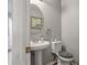 Clean and bright half bathroom with pedestal sink and toilet at 1762 Wood Stork Dr, Hampton, GA 30228