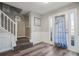 Bright entryway with staircase, wood-look floors, and white trim at 1762 Wood Stork Dr, Hampton, GA 30228