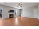 Living room with fireplace, hardwood floors and stairs at 1762 Wood Stork Dr, Hampton, GA 30228