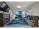 Living area with a fireplace and blue area rug at 1762 Wood Stork Dr, Hampton, GA 30228