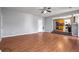 Spacious living room with hardwood floors, fireplace, and kitchen view at 1762 Wood Stork Dr, Hampton, GA 30228