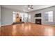 Hardwood floor living room with fireplace and kitchen view at 1762 Wood Stork Dr, Hampton, GA 30228