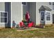 Small patio with red chairs and umbrella at 1762 Wood Stork Dr, Hampton, GA 30228