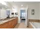 Double vanity bathroom with granite countertop and view to bedroom at 2950 Mount Wilkinson Se Pkwy # 304, Atlanta, GA 30339