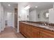 Elegant bathroom with double vanity, granite countertop, and large mirror at 2950 Mount Wilkinson Se Pkwy # 304, Atlanta, GA 30339