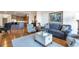 Spacious living room with hardwood floors, comfy seating, and access to kitchen at 2950 Mount Wilkinson Se Pkwy # 304, Atlanta, GA 30339
