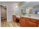 Double vanity bathroom with updated flooring and walk-in shower at 8136 Woodland Se Ct, Covington, GA 30014