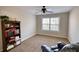 Spacious bedroom with ceiling fan and large window at 8136 Woodland Ct Se, Covington, GA 30014