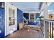 Inviting back porch featuring a wooden bench, light fixtures and outdoor views at 930 Custer St, Atlanta, GA 30354
