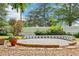 Backyard with stone patio and surrounding garden beds with flowers and greenery at 930 Custer St, Atlanta, GA 30354