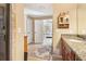 Bright bathroom featuring granite counters and tile flooring leading to a bedroom at 930 Custer St, Atlanta, GA 30354